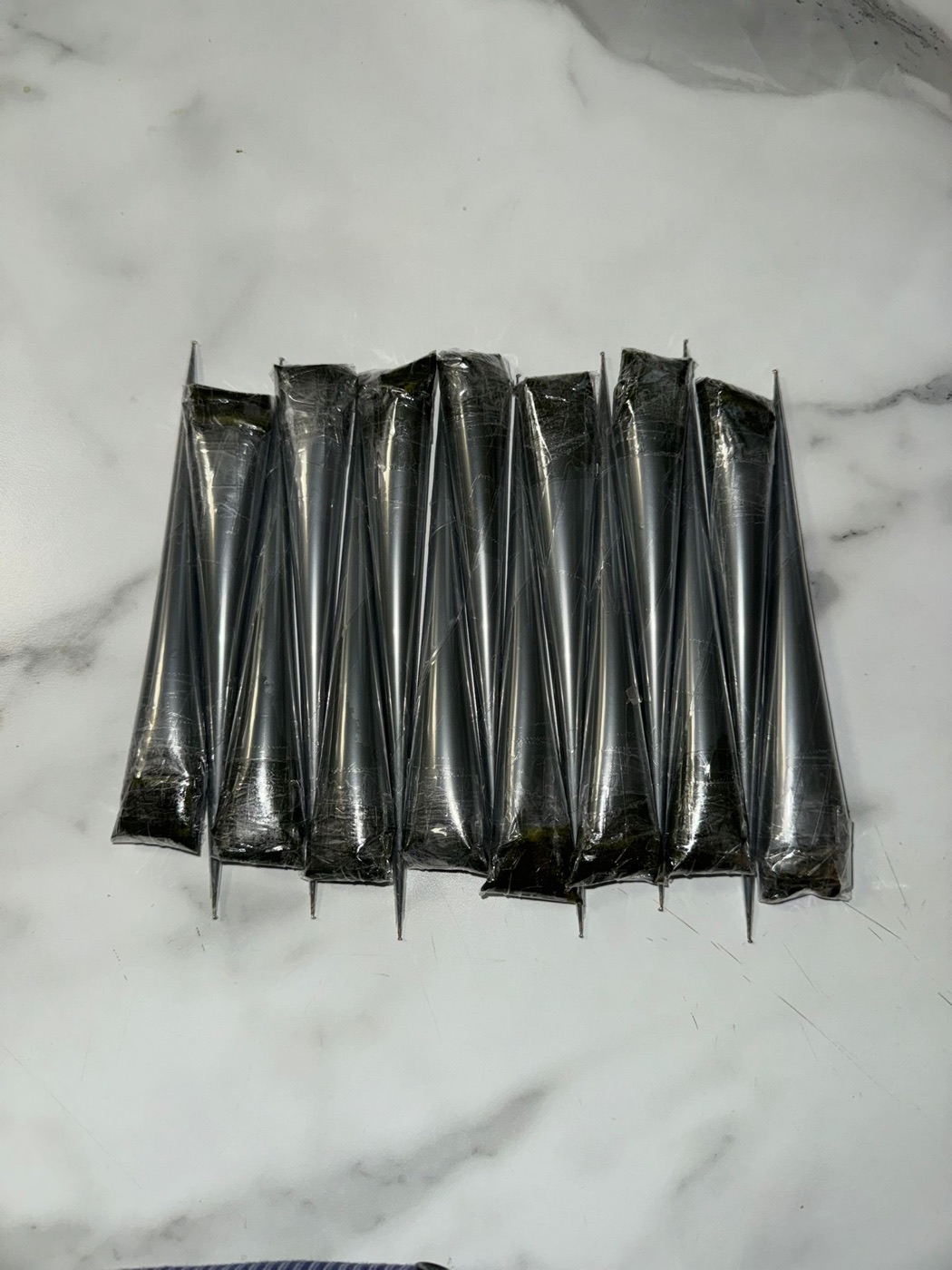 Freshly rolled organic henna cones ready for a booking